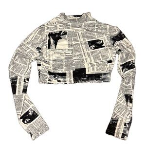 Newspaper print cropped long sleeve top.